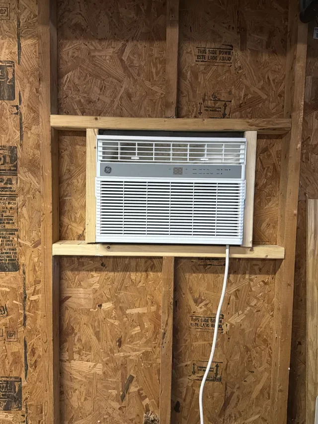 A through-wall air-conditioning unit framed into an exterior wall opening