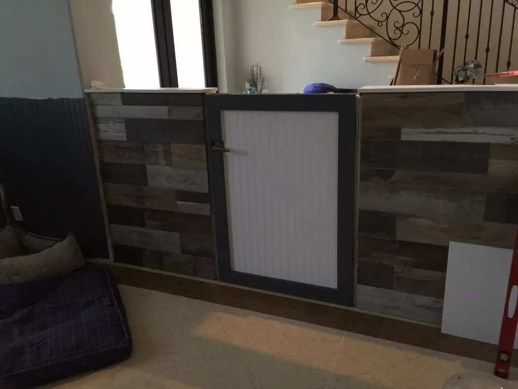 Reclaimed-plank half wall with a custom framed gate - finished and hung.